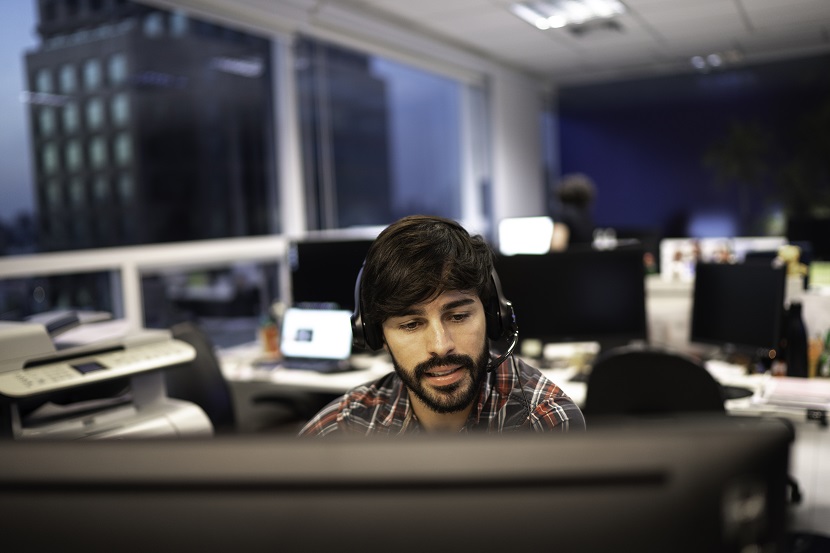 Employee working with headset in office callcenter