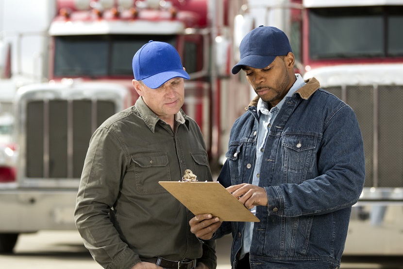 A royalty free image from the trucking industry of two truck drivers having a meeting.