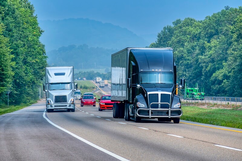 Tractor-trailers driving on a road